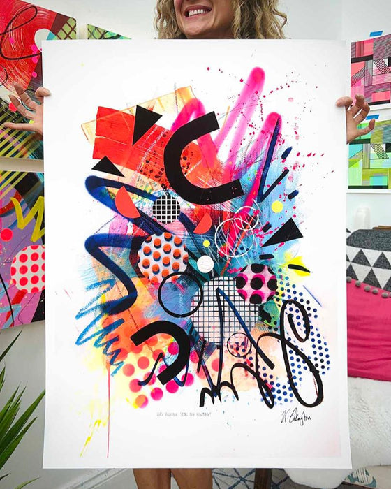 The artist Kate Elkington holding a large, A1 sized, vibrant, colourful abstract artwork featuring bold, graphic shapes, dynamic brushstrokes, and playful patterns. The composition includes splashes of neon pink, orange, and blue, layered with geometric elements such as dots, grids, and curved black lines, radiating energy and movement.