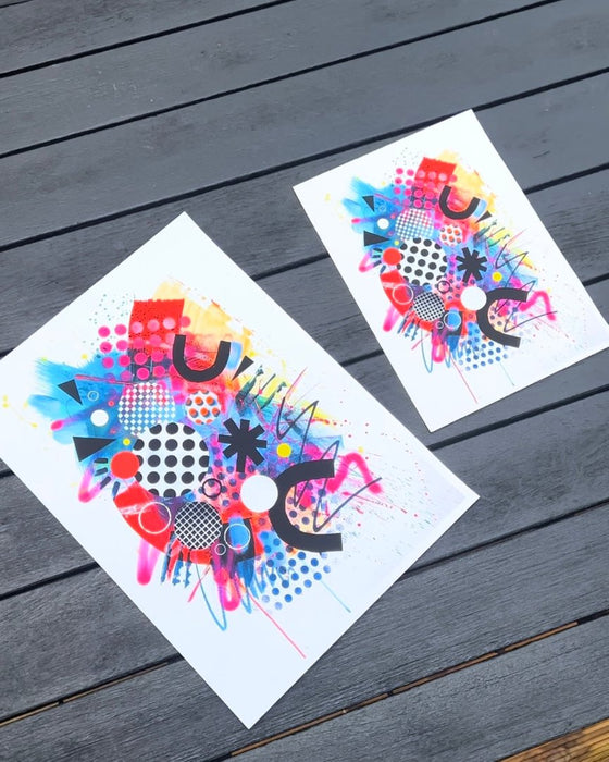 Two vibrant abstract fine art prints filled with bold shapes, patterns, and dynamic colours in sizes A4 and A3. The design features overlapping circles, triangles, and curved elements in vivid tones of pink, orange, blue, and yellow, accented with polka dots, grids, and energetic brushstrokes. The design conveys a sense of playful creativity and movement.