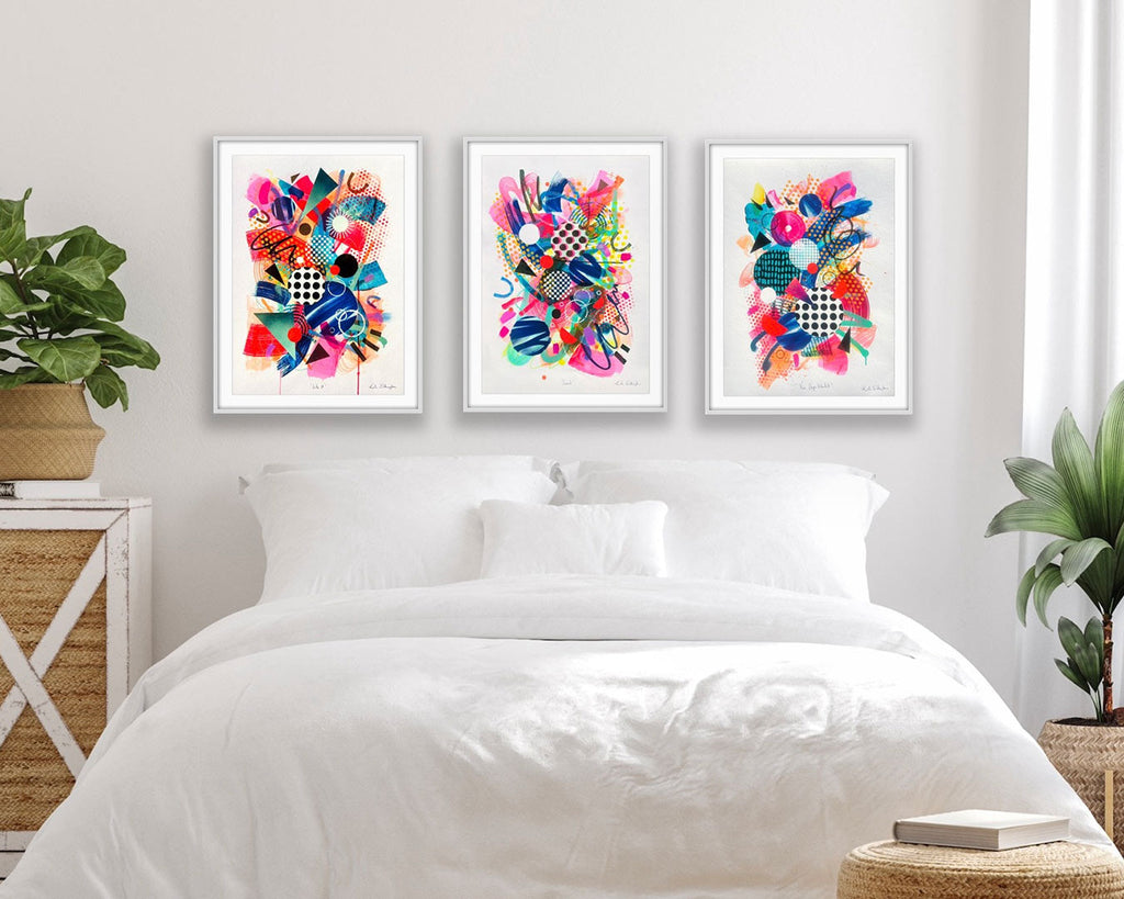 Trio Triptych Gallery Set Of Colourful Abstract Fine Art Prints In White Frames Hung Above A Bed By Kate Elkington 