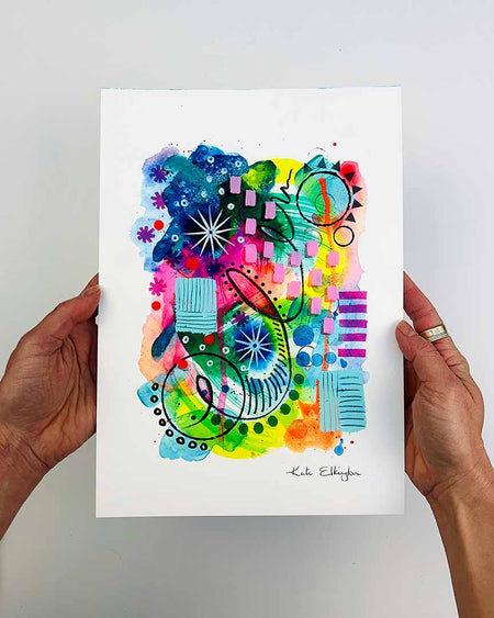 The artist Kate Elkington's hands holding  an A4 Sized vibrant, abstract giclée art print, featuring a playful mix of shapes and colours. Greens, yellows, blues, indigo and pinks are blended with soft washes of watercolour, overlaid with whimsical patterns like dots, stars, and swirls. Free-flowing lines and dynamic brushstrokes create a sense of movement, while geometric elements such as squares and circles add structure.