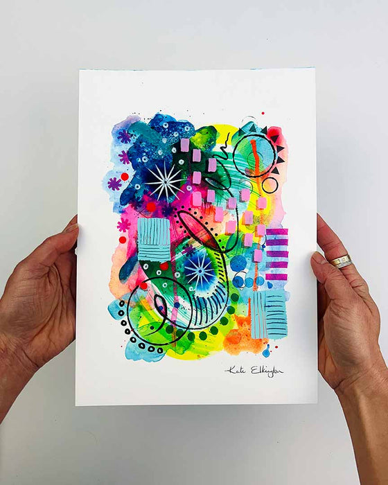 The artist Kate Elkington's hands holding  an A4 Sized vibrant, abstract giclée art print, featuring a playful mix of shapes and colours. Greens, yellows, blues, indigo and pinks are blended with soft washes of watercolour, overlaid with whimsical patterns like dots, stars, and swirls. Free-flowing lines and dynamic brushstrokes create a sense of movement, while geometric elements such as squares and circles add structure.