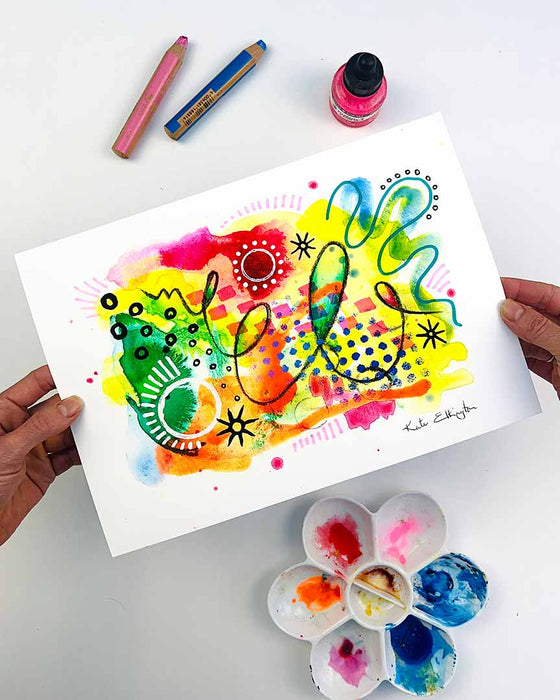 The hands of the artist Kate Elkington holding an A4 sized vibrant abstract giclée art print in landscape orientation, featuring a playful mix of shapes and colours. Bright yellows, oranges, blues, greens, and pinks are blended with soft washes of watercolour, overlaid with whimsical patterns like dots, stars, and swirls. Free-flowing lines and dynamic brushstrokes create a sense of movement, while geometric elements such as squares and circles add structure. The overall composition is uplifting and joyful.