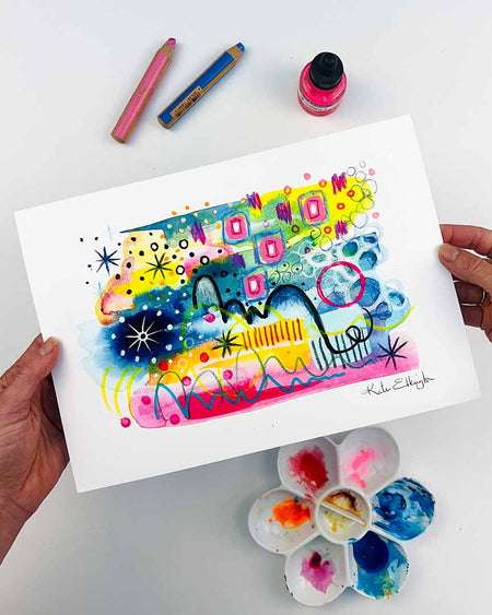 The hands of the artist Kate Elkington holding an A4 sized vibrant abstract giclée art print in landscape orientation, featuring a playful mix of shapes and colours. Goldne yellows, blues, indigo and pinks are blended with soft washes of watercolour, overlaid with whimsical patterns like dots, stars, and swirls. Free-flowing lines and dynamic brushstrokes create a sense of movement, while geometric elements such as squares and circles add structure. The overall composition is uplifting and joyful.
